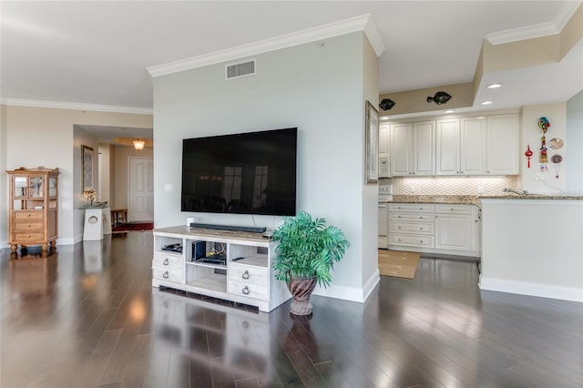 living room featuring dark hardwood / wood-style flooring and crown molding