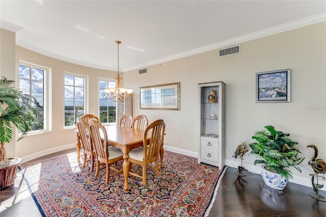 dining area with a textured ceiling, a notable chandelier, and crown molding