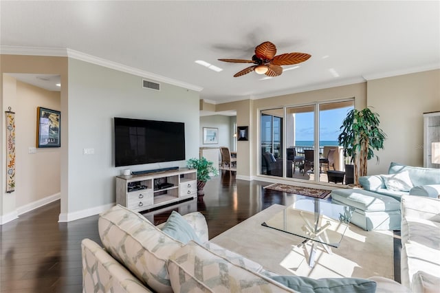 living room with dark wood-type flooring, ceiling fan, and crown molding