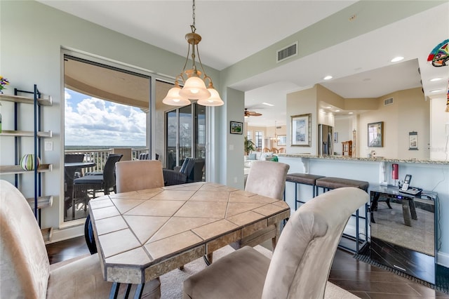 dining area featuring ceiling fan and dark hardwood / wood-style floors