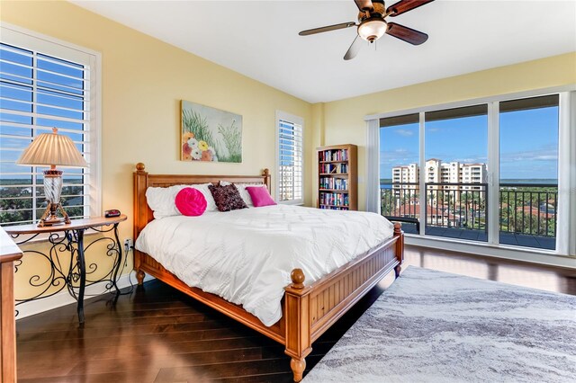 bedroom with dark wood-type flooring, ceiling fan, and access to outside