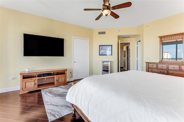 bedroom with ceiling fan and dark hardwood / wood-style flooring