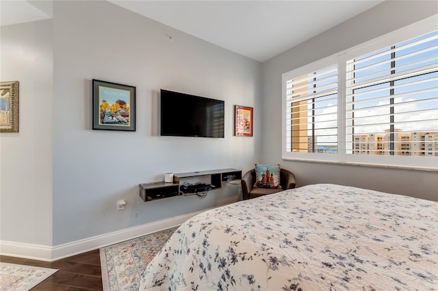 bedroom with dark wood-type flooring