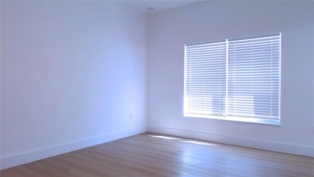 unfurnished room with hardwood / wood-style flooring