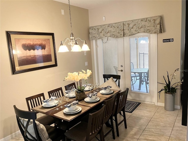 tiled dining area with an inviting chandelier