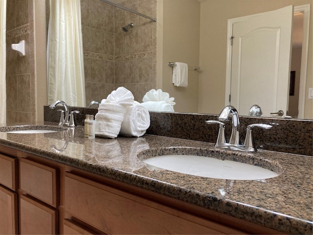 bathroom featuring vanity and curtained shower