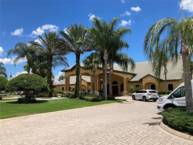 mediterranean / spanish-style home with a front lawn