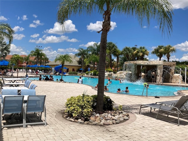 view of swimming pool with a patio and pool water feature