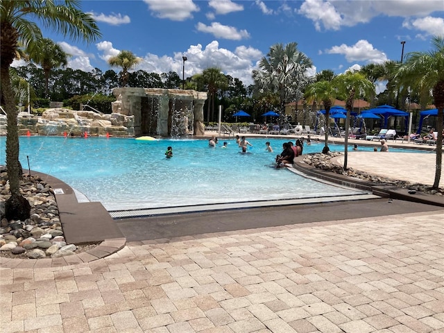 view of pool with pool water feature