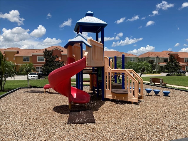 view of playground with a lawn