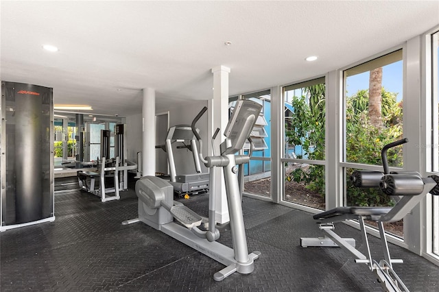 exercise room featuring recessed lighting and floor to ceiling windows