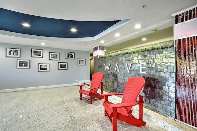 living area with a textured ceiling