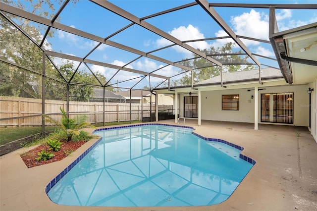 view of pool with a patio and glass enclosure