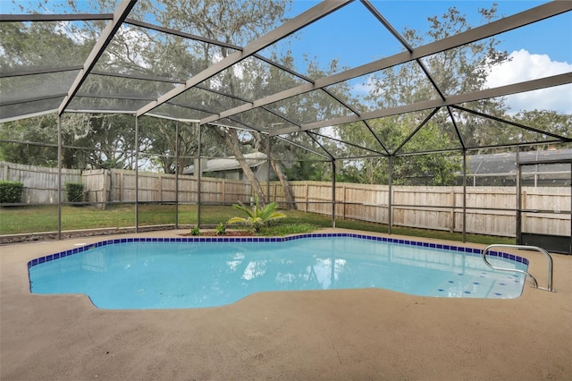 view of pool with a patio area and glass enclosure