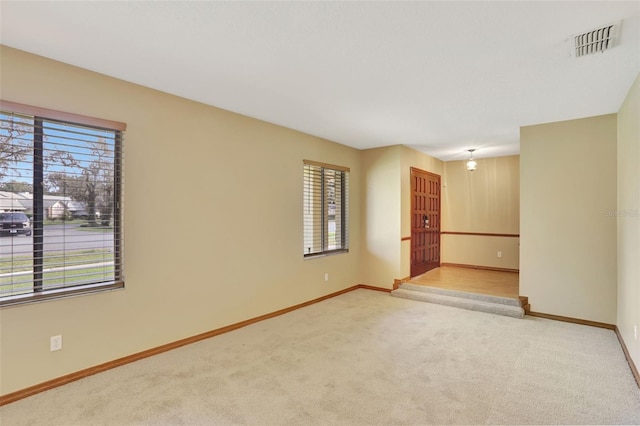 empty room with plenty of natural light and light colored carpet