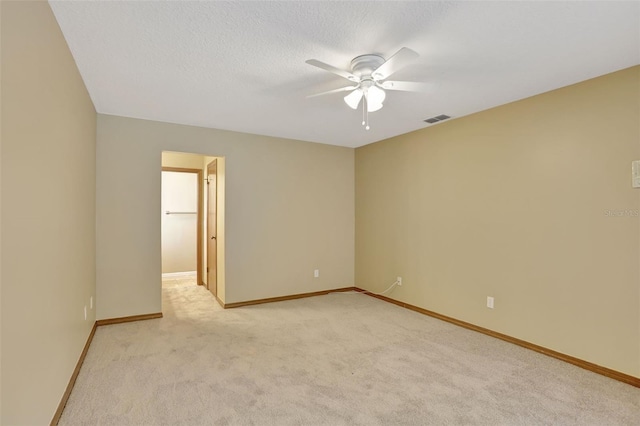 carpeted empty room featuring a textured ceiling and ceiling fan