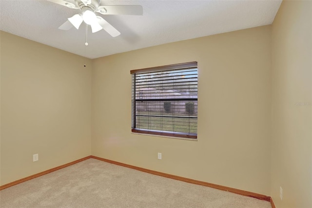 carpeted empty room featuring a textured ceiling and ceiling fan