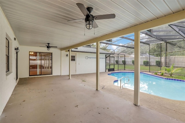 view of swimming pool featuring ceiling fan, a lanai, a lawn, and a patio area