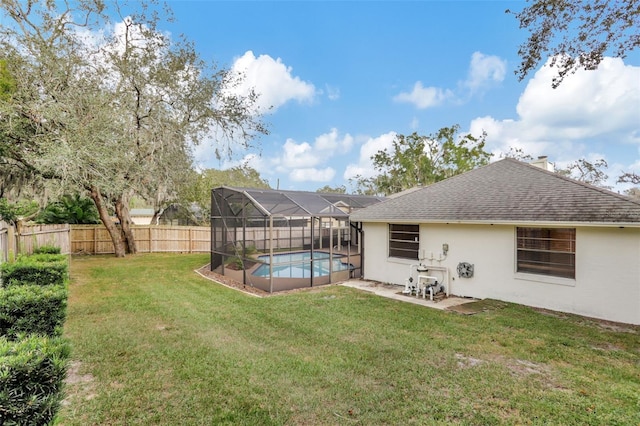 view of yard with a fenced in pool and a lanai