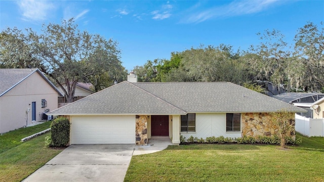 ranch-style house featuring a front yard and a garage