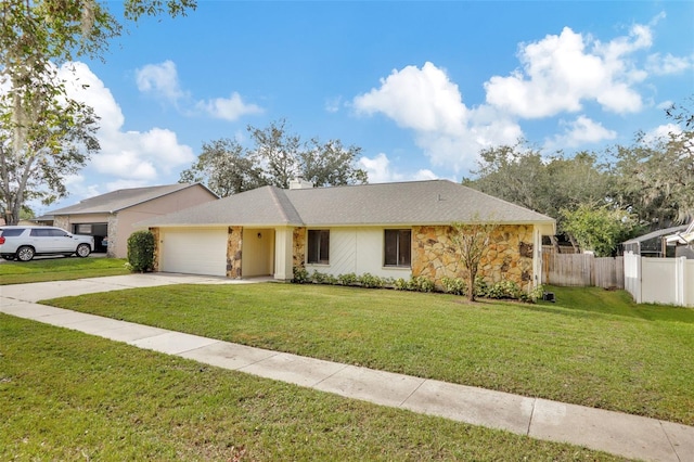 ranch-style home featuring a garage and a front lawn