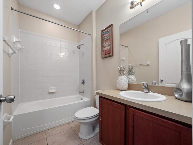 full bathroom featuring vanity, tiled shower / bath combo, toilet, and tile patterned flooring