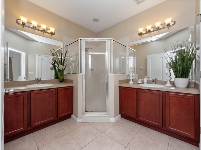 bathroom with vanity, an enclosed shower, and tile patterned flooring