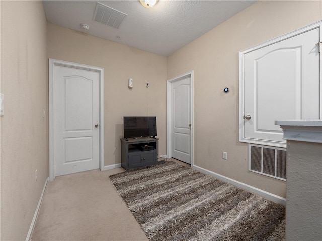 living room featuring light carpet and a textured ceiling