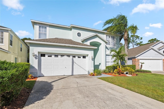 view of front property featuring a garage and a front lawn