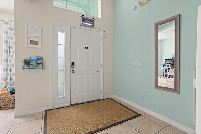 foyer entrance featuring light tile patterned floors and plenty of natural light