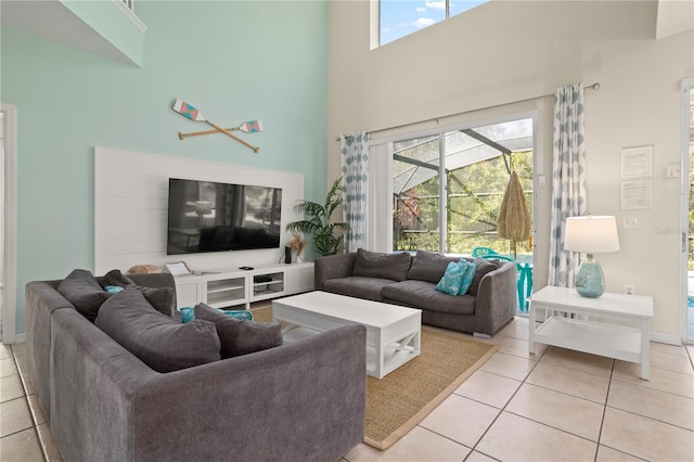 1055 Lake Berkley Dr, Kissimmee, FL 34746 - living room featuring a towering ceiling, light tile patterned floors, and plenty of natural light