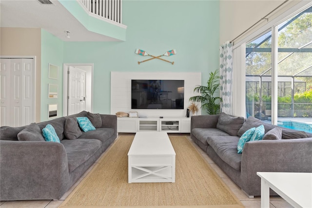 living room with tile patterned floors and a towering ceiling