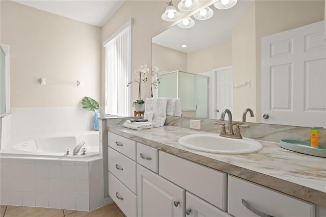 1055 Lake Berkley Dr, Kissimmee, FL 34746 - bathroom featuring vanity, a bath, a stall shower, and tile patterned flooring
