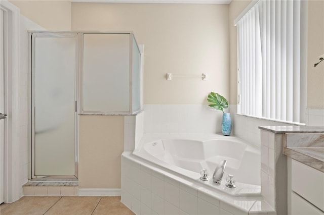 bathroom with separate shower and tub and tile patterned floors