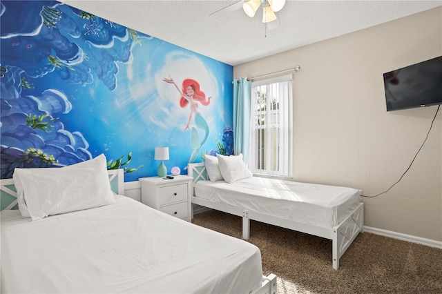 carpeted bedroom with a textured ceiling and ceiling fan