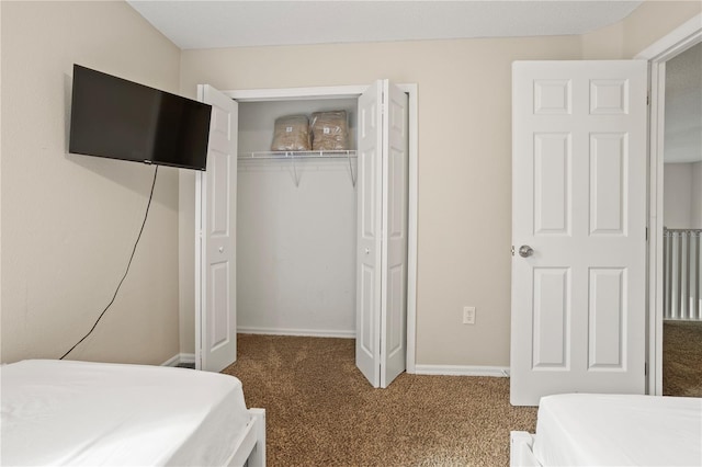 bedroom with carpet flooring and a closet