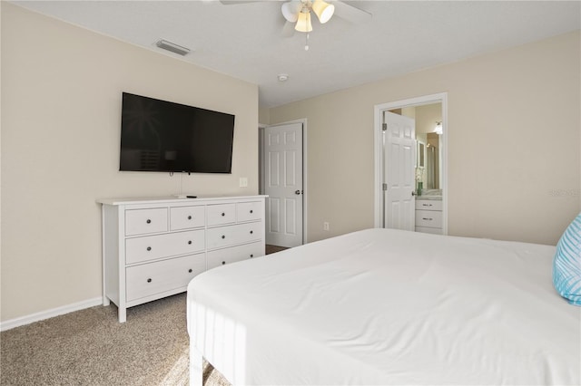 carpeted bedroom featuring ensuite bathroom and ceiling fan