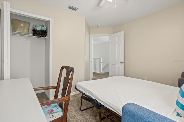 carpeted bedroom featuring ceiling fan and a closet