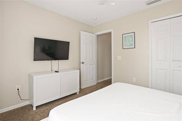 carpeted bedroom with ceiling fan and a closet