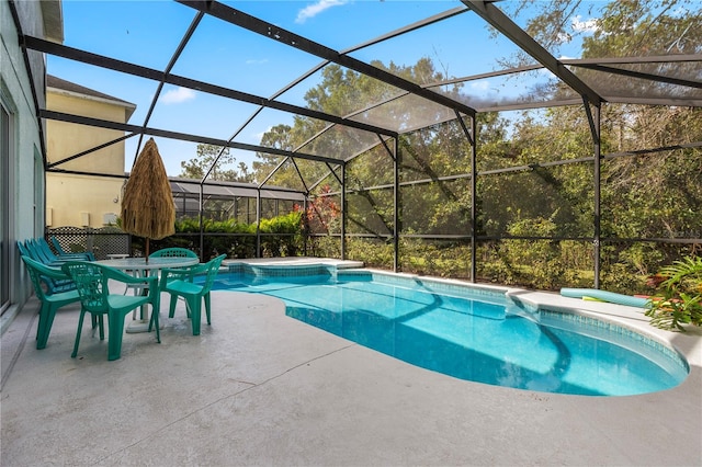 view of swimming pool featuring a patio and glass enclosure