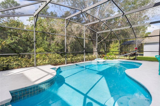 view of pool with glass enclosure