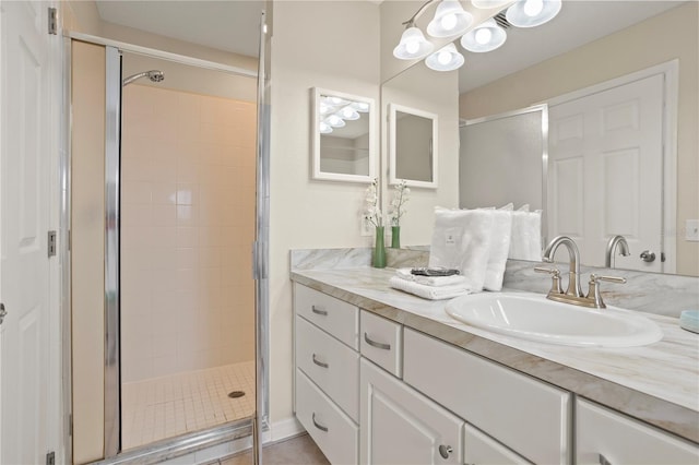 bathroom featuring tile patterned flooring, vanity, and walk in shower