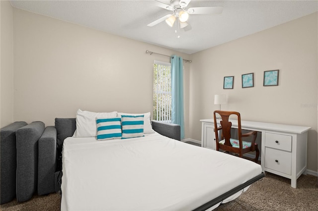 carpeted bedroom with ceiling fan and a textured ceiling