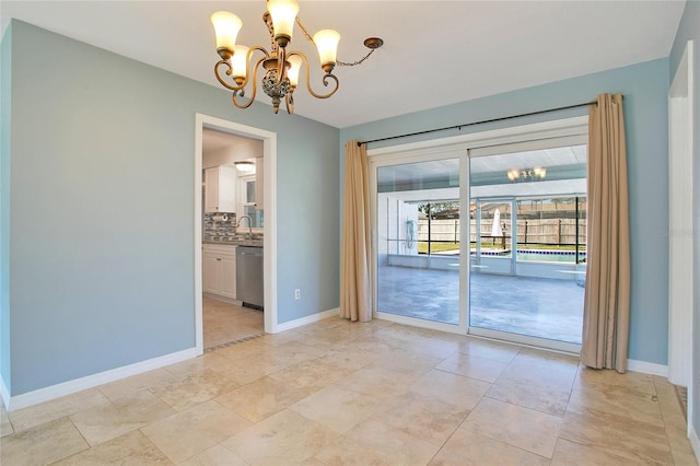 unfurnished room with a chandelier and sink