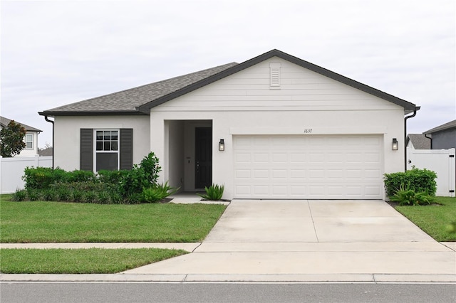 ranch-style house with a garage and a front lawn