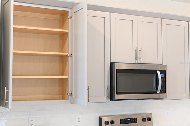 room details with white cabinetry and tasteful backsplash