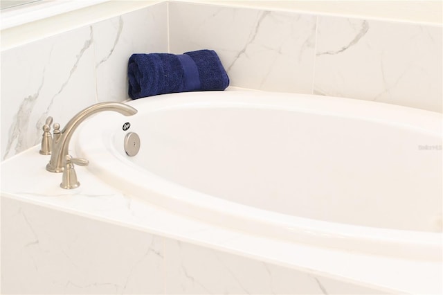 bathroom featuring a relaxing tiled tub