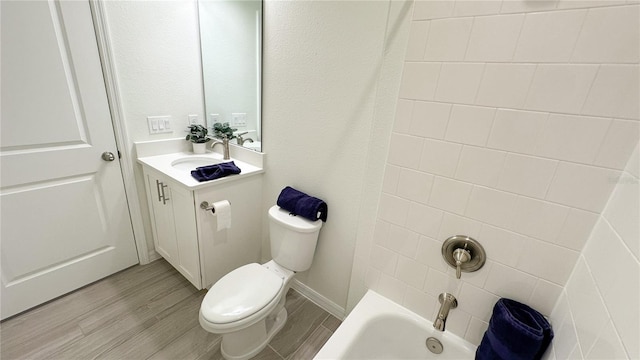 full bathroom featuring vanity, toilet, shower / washtub combination, and hardwood / wood-style floors