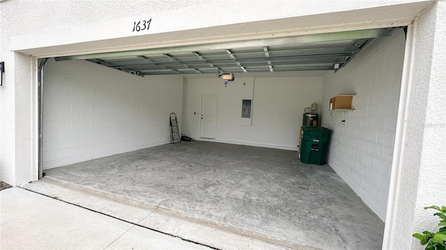 garage with a garage door opener and electric panel