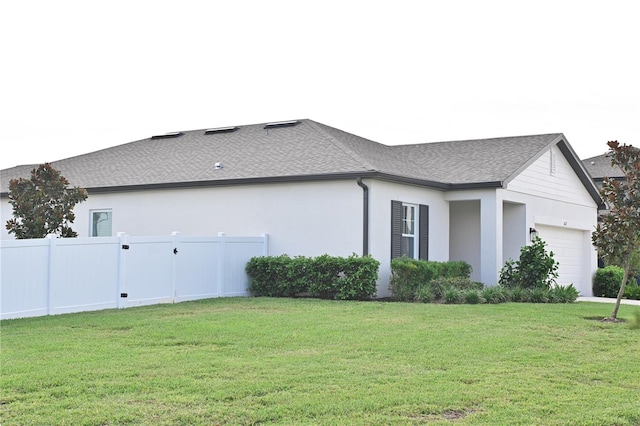 view of home's exterior featuring a yard and a garage